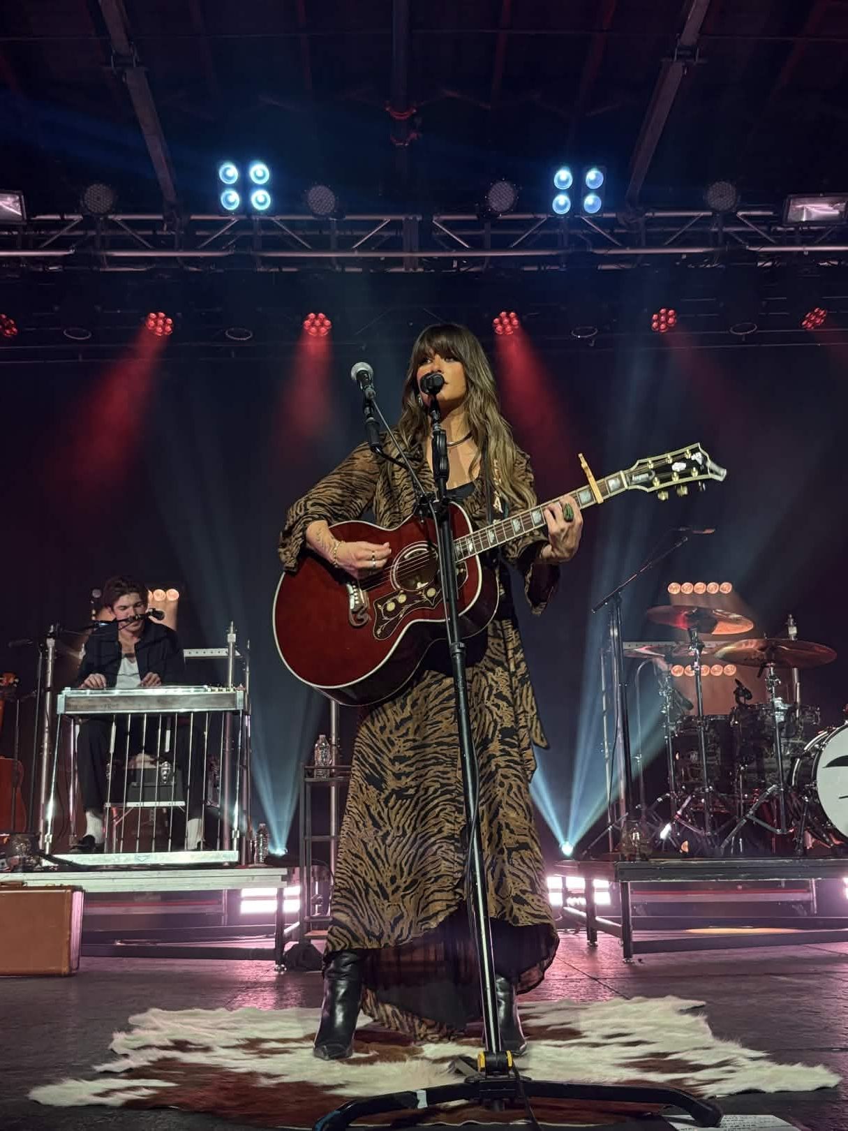 Ella Langley performing on stage with her guitar during a 2025 concert