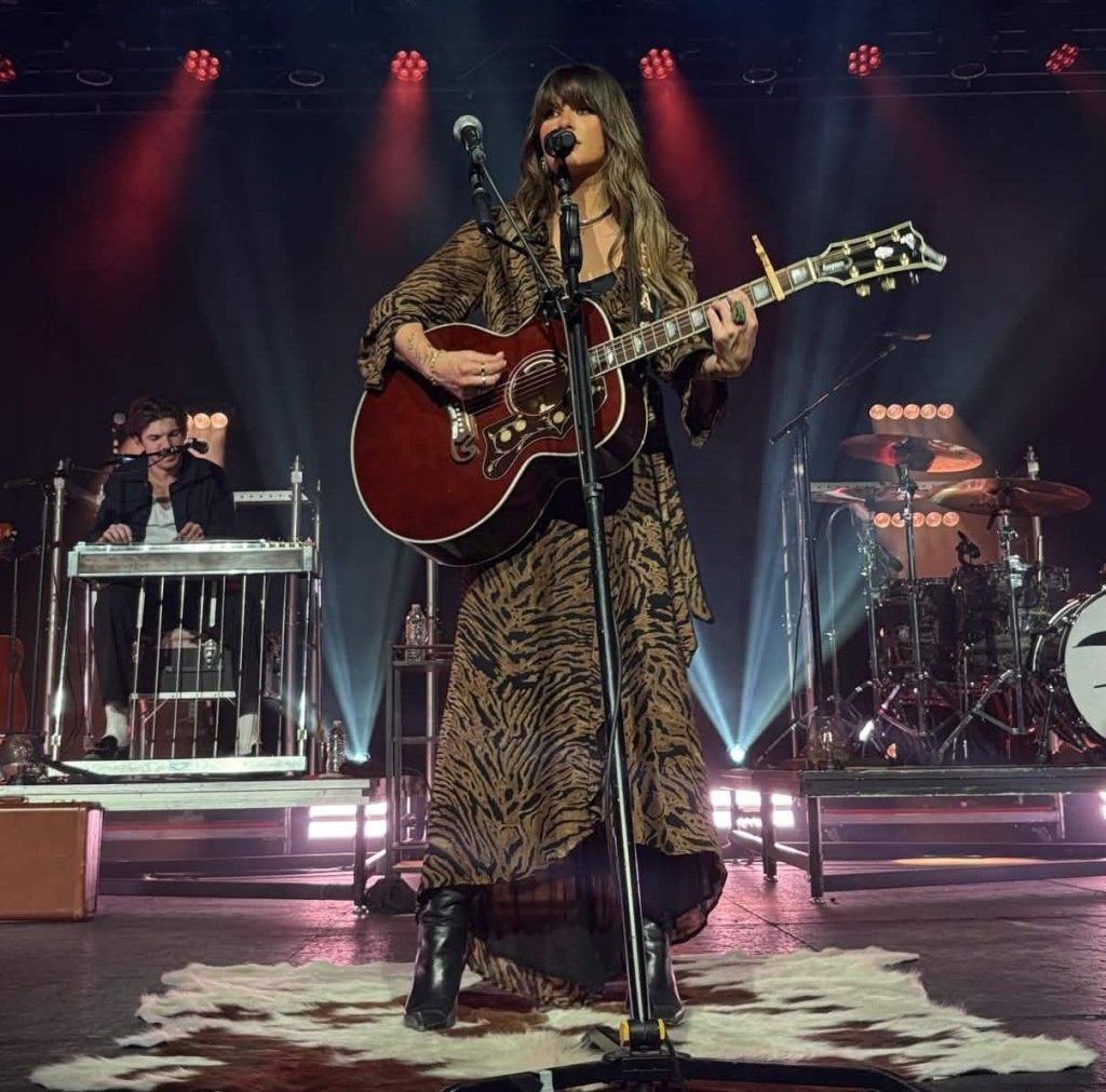 Ella Langley performing live on stage with guitar at a 2025 concert in Grand Rapids, Michigan