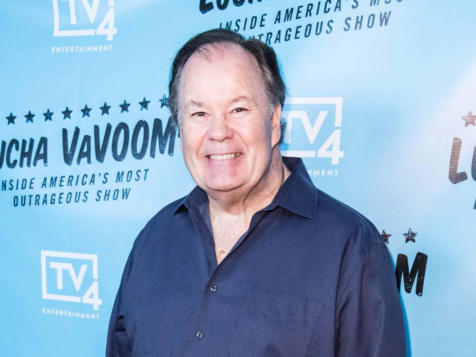 Dennis Haskins smiling at the Lucha VaVOOM premiere red carpet