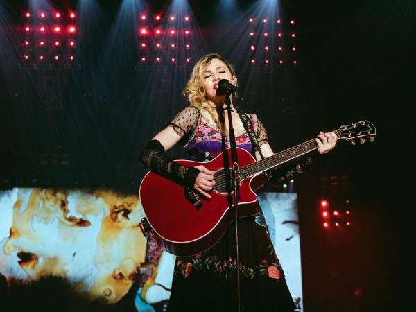 Madonna performing with a guitar on her Rebel Heart Tour in Philadelphia in 2015