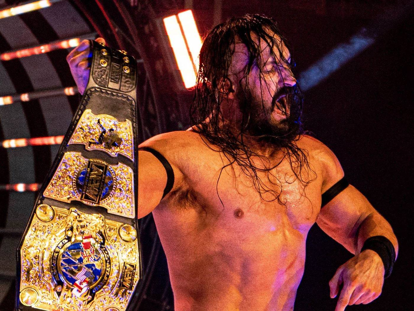 AEW star Pac holding a championship belt in the ring, June 2022
