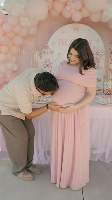 Taylor Lautner kissing wife Tay's baby bump during her pregnancy