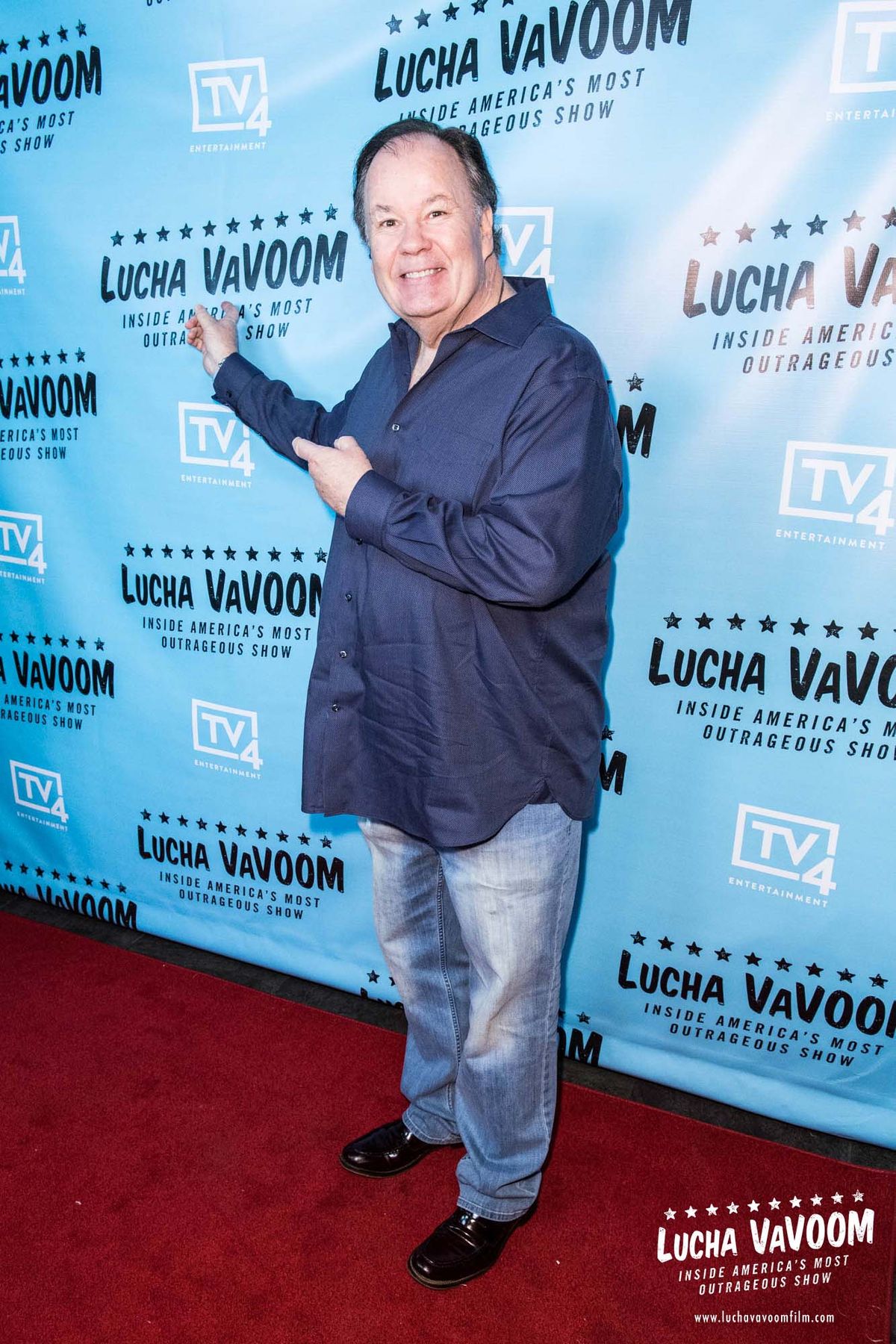 Dennis Haskins pointing and smiling at the Lucha VaVOOM film premiere