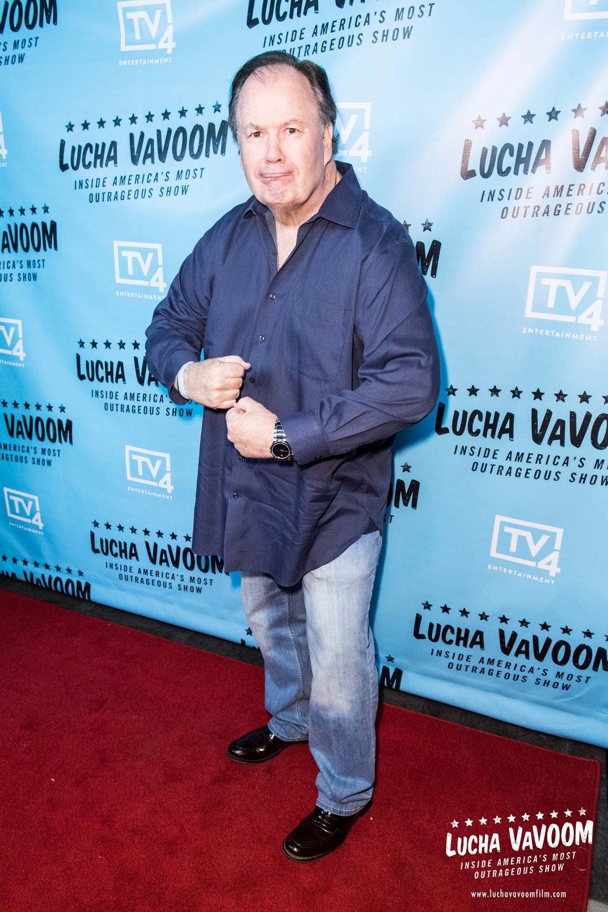 Dennis Haskins poses full-length on the red carpet at the Lucha VaVOOM premiere