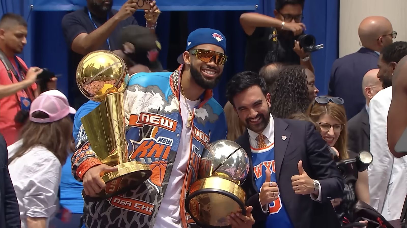 Karl-Anthony Towns holds the NBA championship trophy at a New York Knicks City Hall celebration