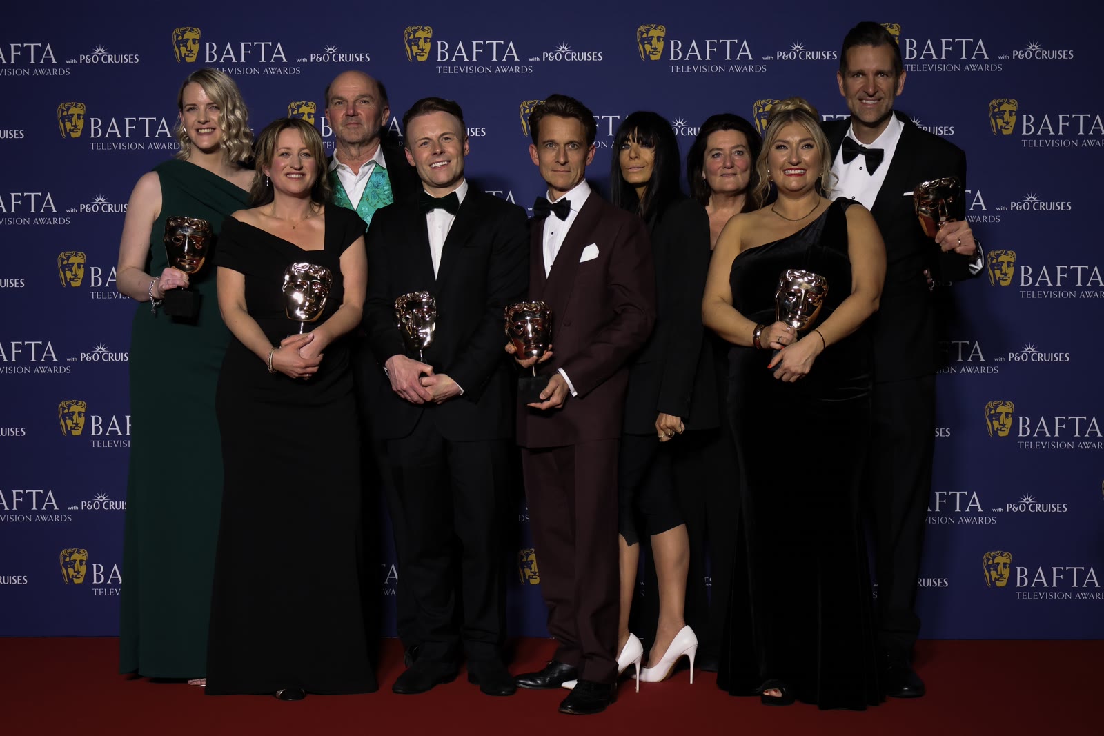 Claudia Winkleman with the cast and crew of The Celebrity Traitors after their win at the BAFTA Television Awards in May 2026