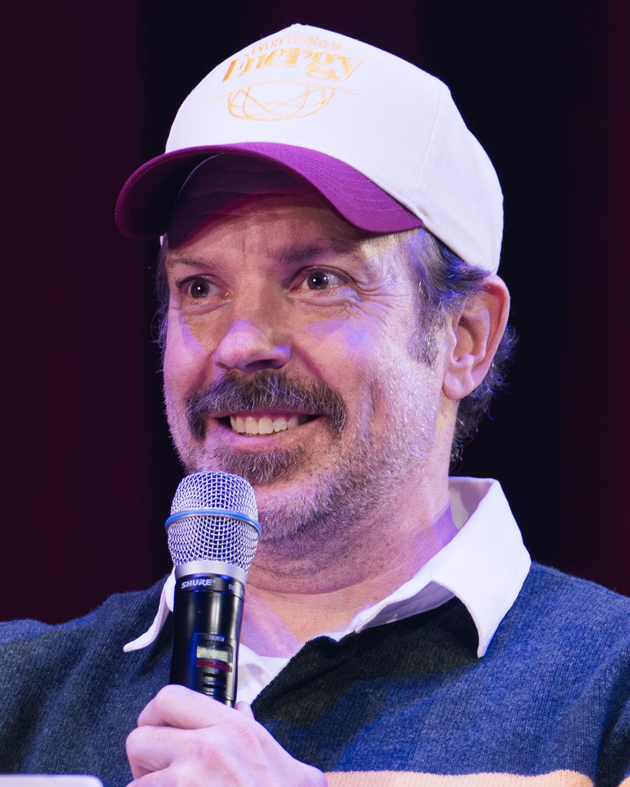 Jason Sudeikis, star of Ted Lasso, speaking into a microphone on stage