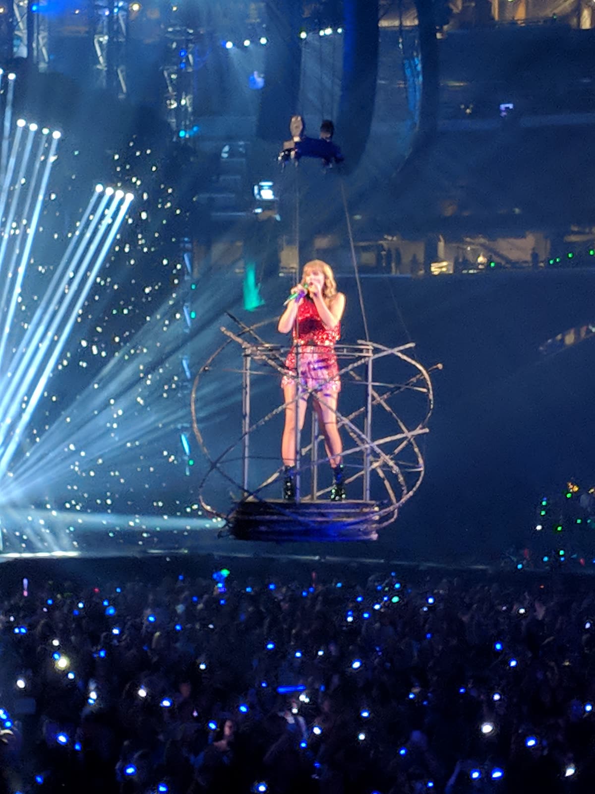 Taylor Swift performing "Delicate" from a hanging platform during the Reputation Stadium Tour