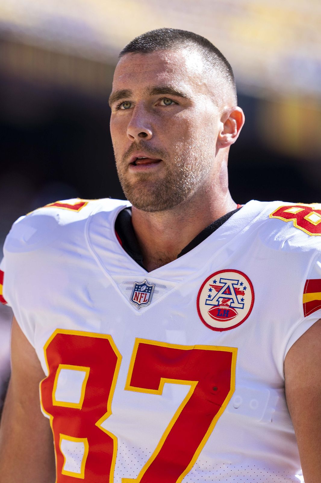 Travis Kelce in a Kansas City Chiefs white No. 87 jersey on the field