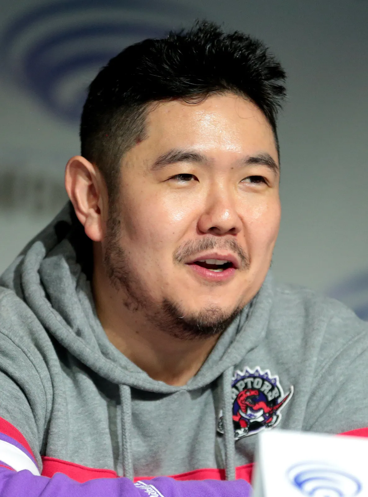 Eric Bauza speaking at a convention panel