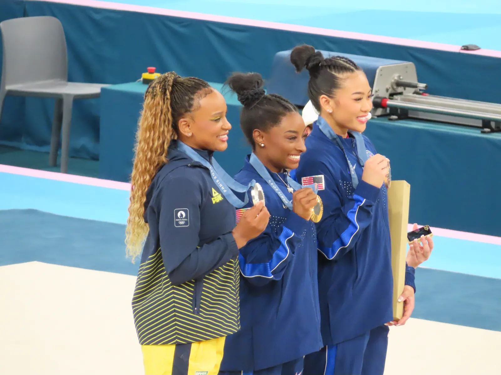Simone Biles (center) with Rebeca Andrade and Suni Lee on the all-around podium at the Paris 2024 Olympics