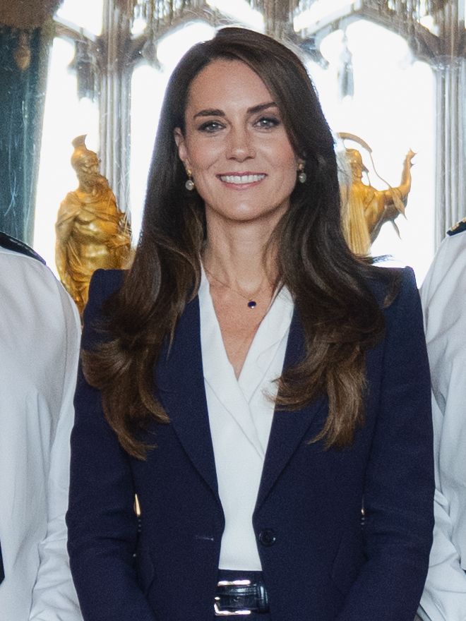 Catherine, Princess of Wales smiling in a navy blazer at Windsor Castle in September 2022.
