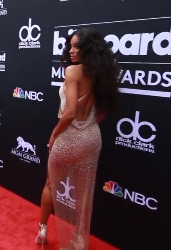 Ciara posing on the red carpet at the 2018 Billboard Music Awards in a sparkling backless gown
