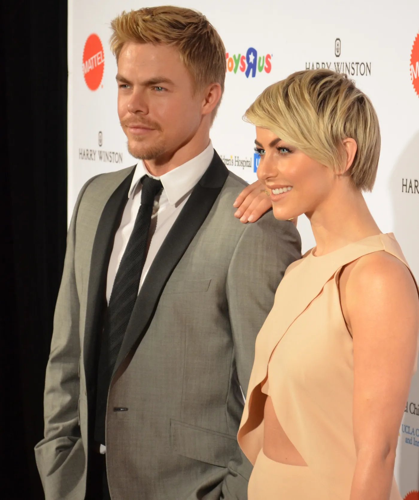 Derek Hough and his sister Julianne Hough posing together at a red carpet event
