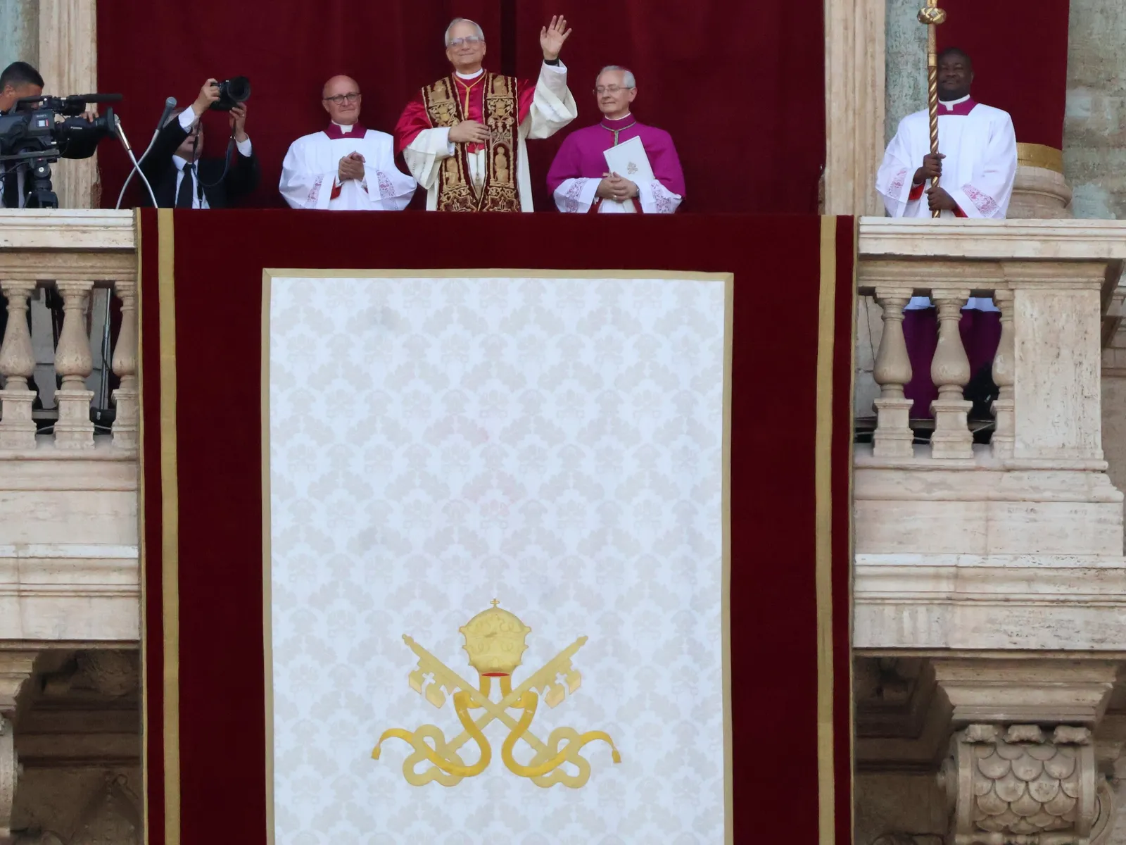 Pope Leo XIV waving from the balcony of St. Peter's Basilica after his election