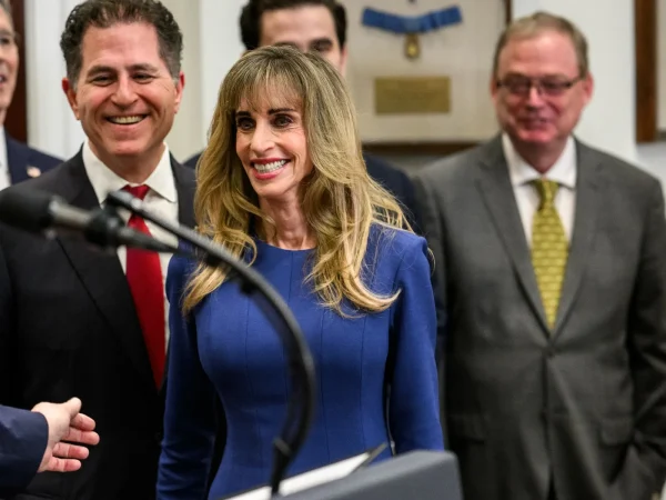 Susan Dell smiling at the White House Trump Accounts announcement, with Michael Dell beside her