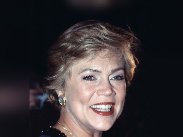 Kathleen Turner smiling at a public event, her full head in frame with clear headroom