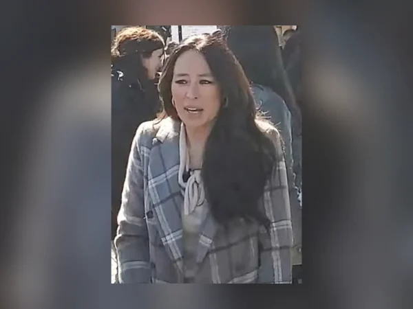 Joanna Gaines smiling outdoors while filming at Magnolia in Waco, Texas