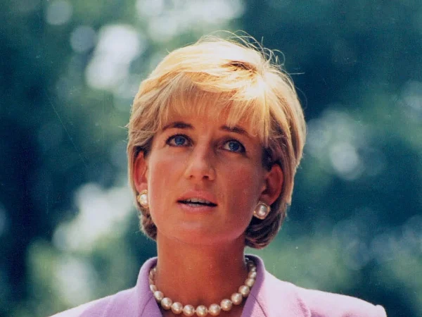 Princess Diana speaking at a Red Cross charity engagement, wearing a pearl necklace