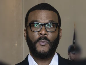 Tyler Perry portrait in 2024 wearing glasses and a suit