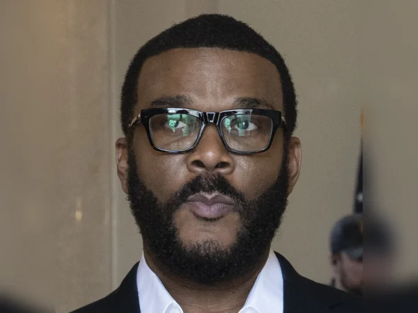 Tyler Perry portrait in 2024 wearing glasses and a suit
