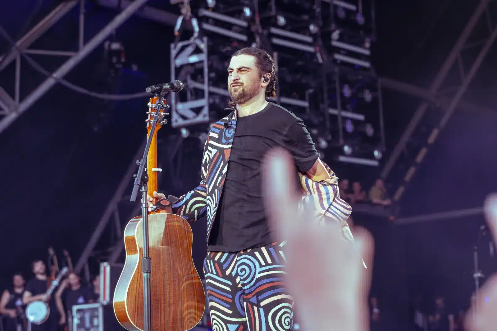 Noah Kahan singing with an acoustic guitar at Glastonbury Festival 2025