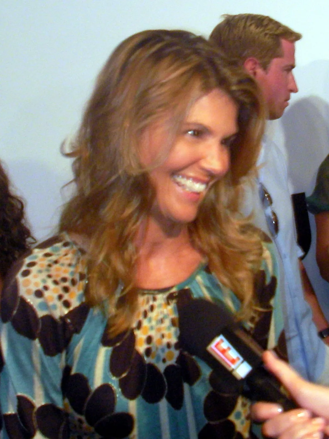 Lori Loughlin smiling while being interviewed on the red carpet