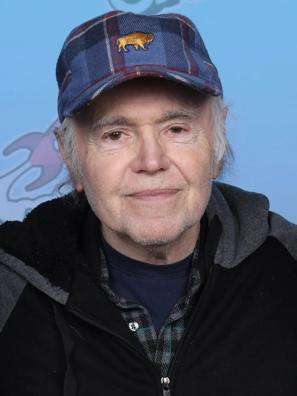 Walter Koenig smiling at GalaxyCon Richmond in 2023, wearing a plaid cap