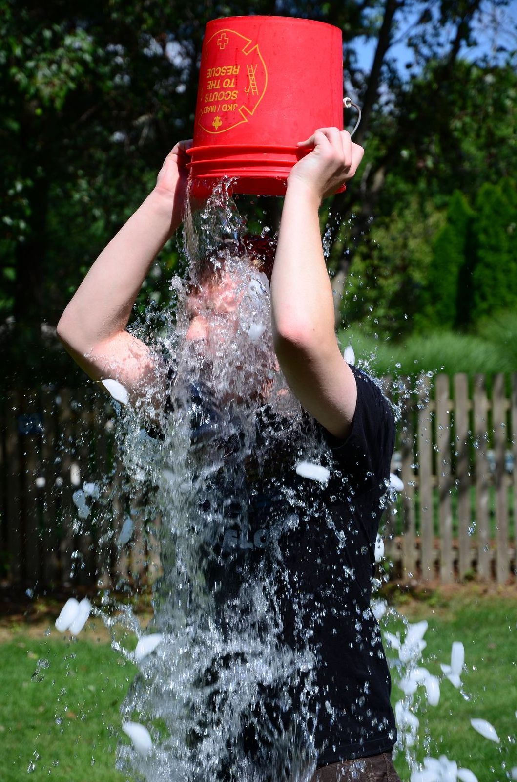A participant in the ALS Ice Bucket Challenge pouring a bucket of ice water over their head