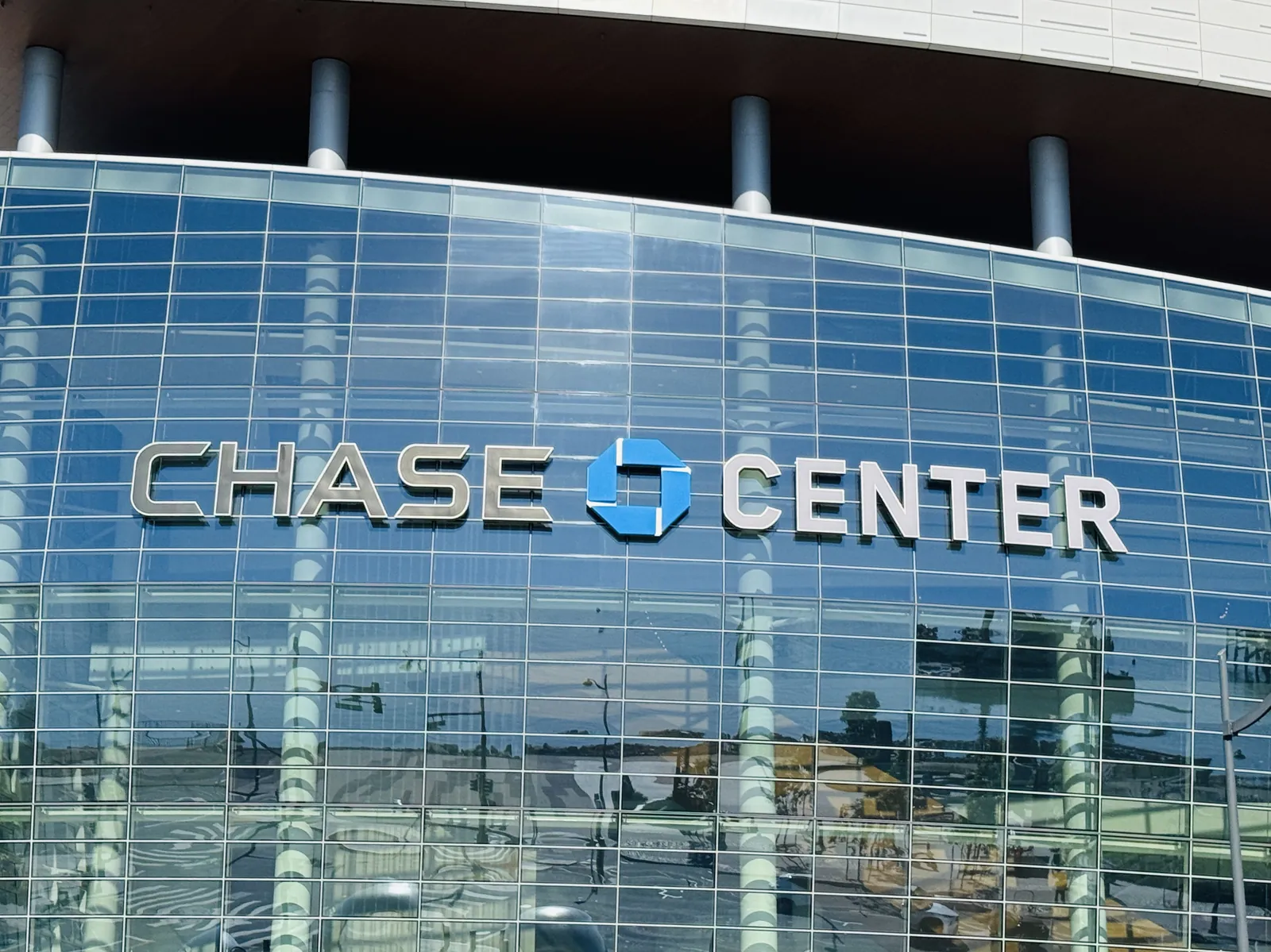 Exterior facade of the Chase Center, home of the Golden State Warriors, with arena signage