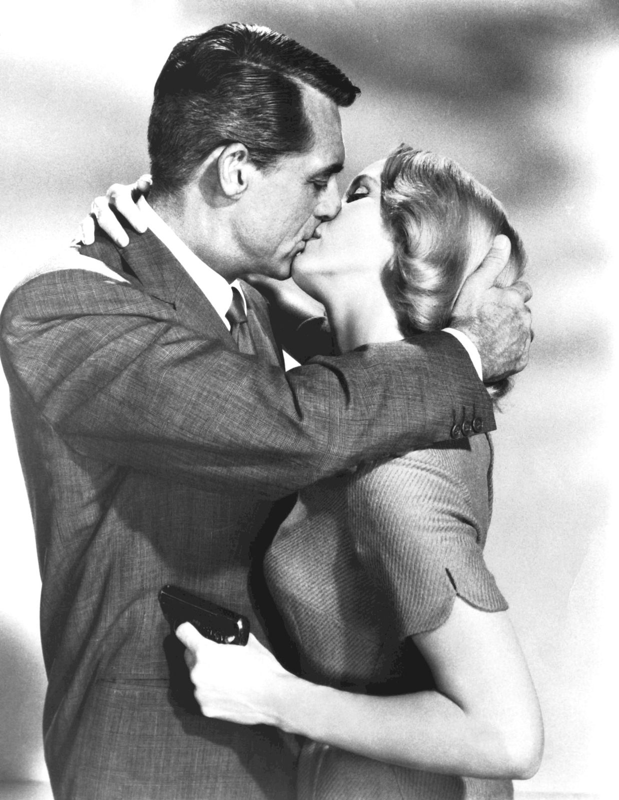 Eva Marie Saint kisses Cary Grant in a still from Alfred Hitchcock's North by Northwest (1959)