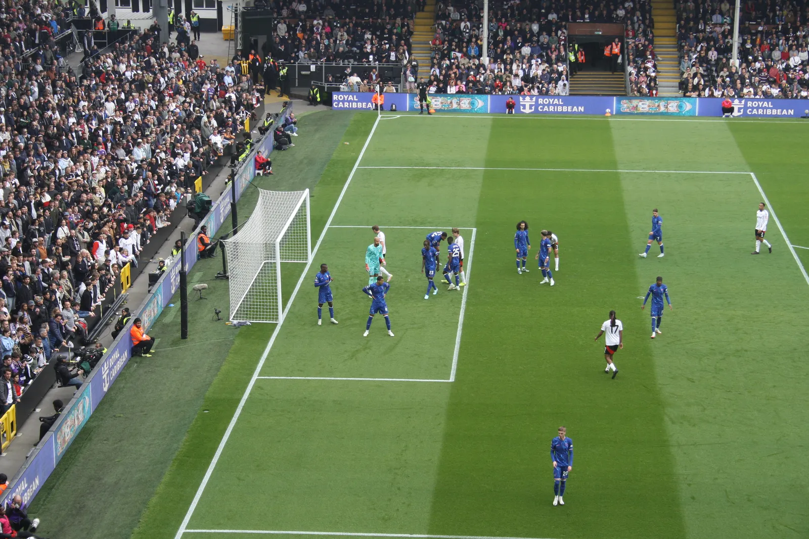 Chelsea and Fulham players contesting a ball near the goal during a Premier League match at Craven Cottage
