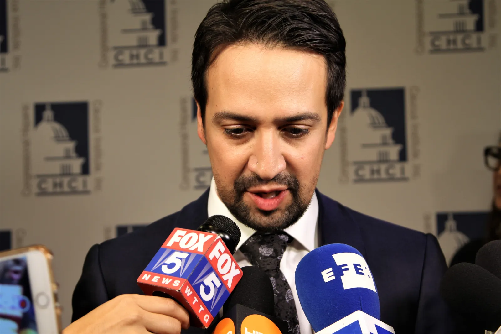 Lin-Manuel Miranda speaking to reporters at a press event