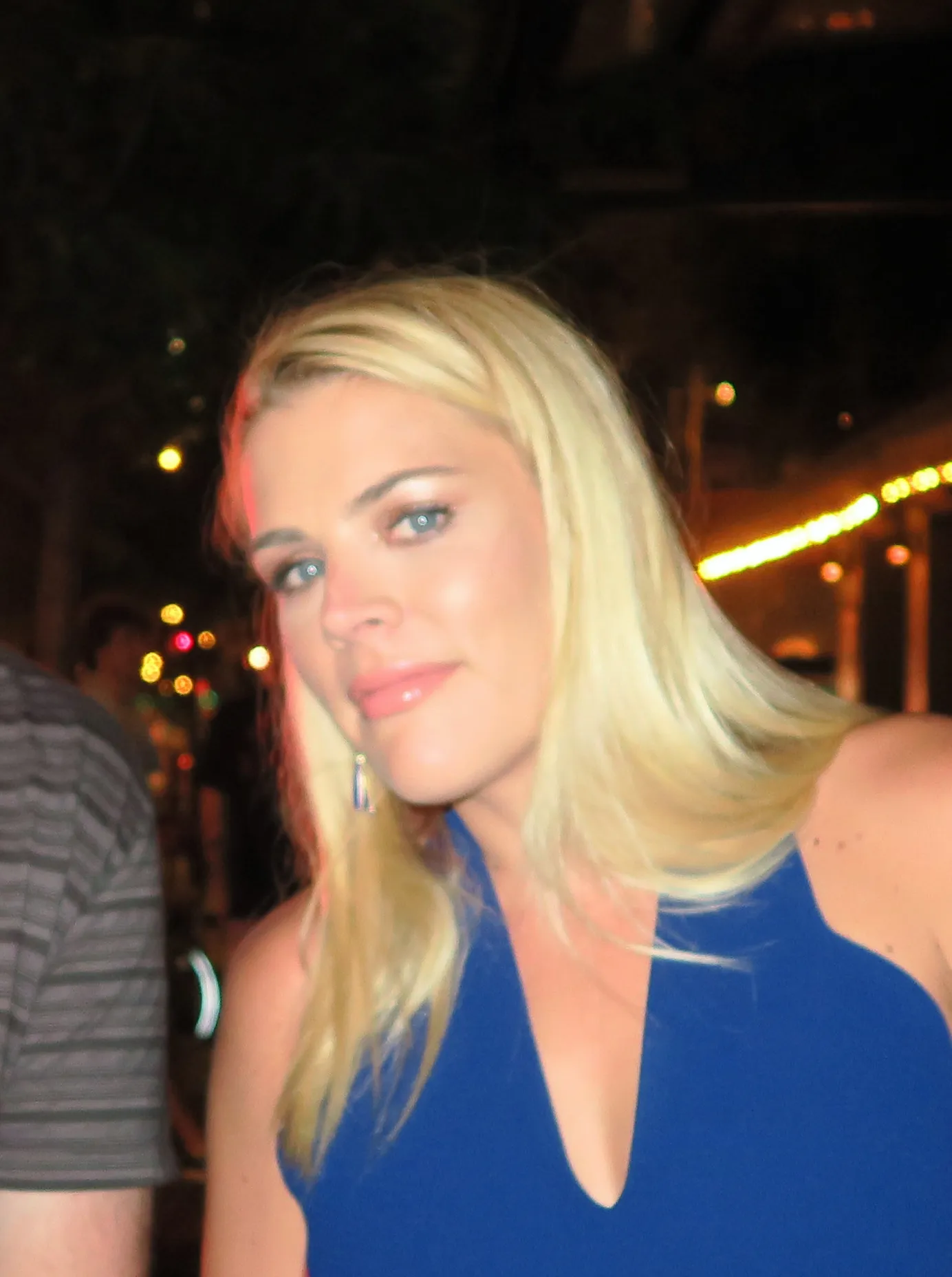 Busy Philipps at a nighttime event in a blue dress