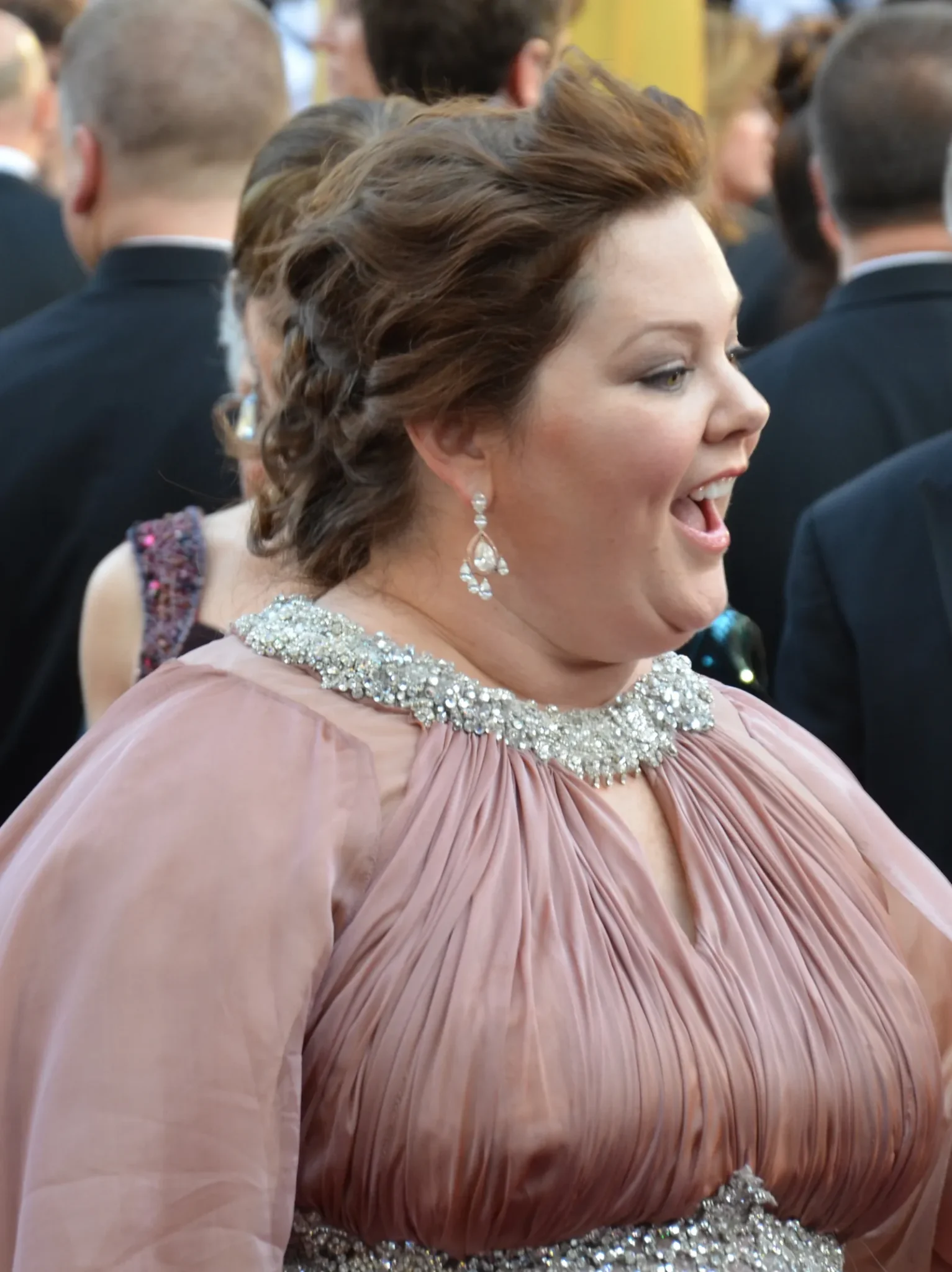 Melissa McCarthy at the 2012 Academy Awards in a pink gown, nominated for Bridesmaids