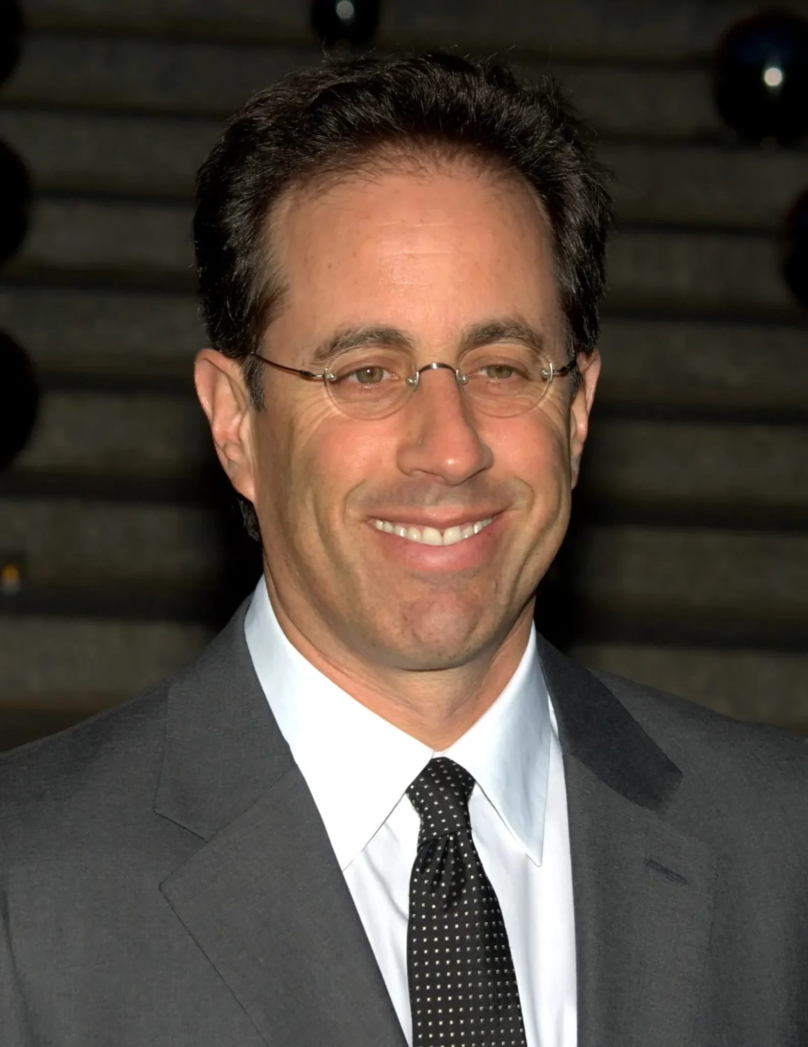 Jerry Seinfeld smiling for photographers — sitcom legends where are they now
