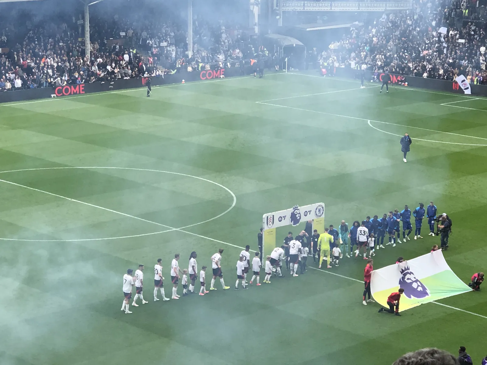 Chelsea and Fulham players lining up on the pitch before kick-off at Craven Cottage