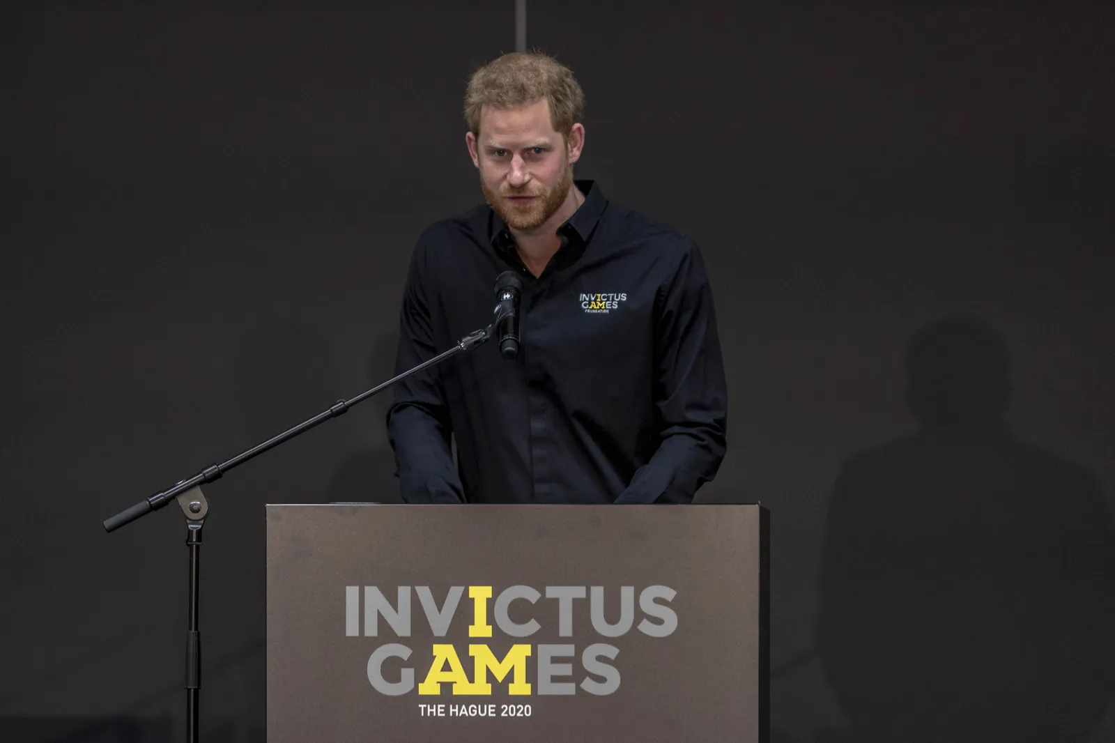 Prince Harry speaking at a podium during the launch of the Invictus Games