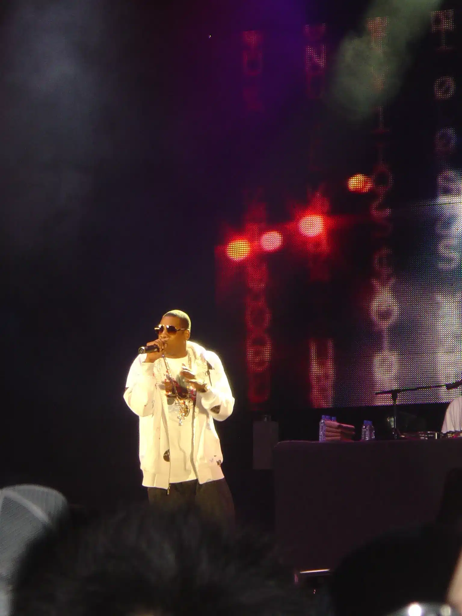 Jay-Z performing on stage with a microphone during a concert