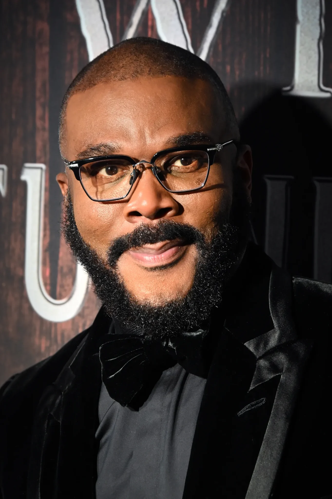 Tyler Perry on the red carpet wearing glasses