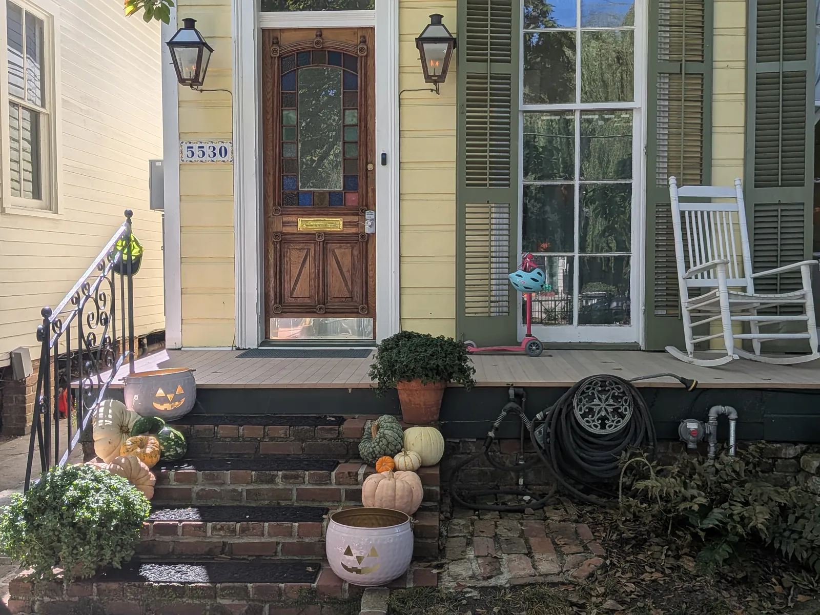 Carved Halloween pumpkins and decorations on a house stoop in New Orleans